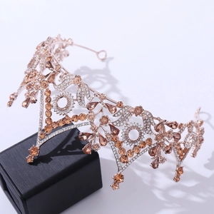 Detail of rose gold bridal crown featuring champagne crystals in a black jewelry box