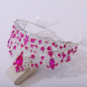 Detailed close-up of a silver baroque crown with pink crystals and secure combs