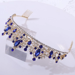 Macro view of bridal crown featuring blue crystals and white rhinestones on gold metal