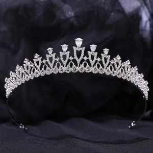 Close-up of bridal silver crown featuring zircon flowers and sparkling teardrop crystals