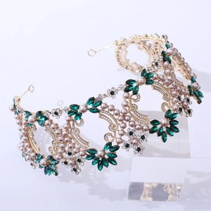 Detail of Baroque bridal crown with emerald crystals and pearls on a gold base