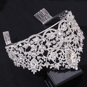 Detailed macro view of silver bridal crown featuring pear-shaped crystals and hair combs