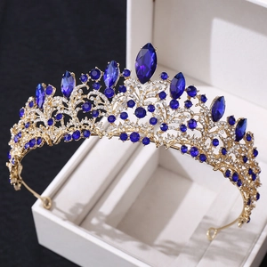 Close-up of luxury bridal crown with deep blue crystals and rhinestones in rose gold