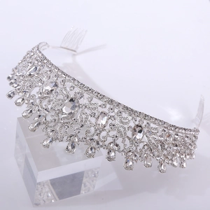 Detailed close-up of a silver leaf bridal crown with green crystals and comb attachment