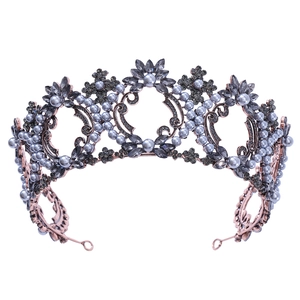 Detail of baroque crown showing grey crystals and blue pearls on vintage metal frame