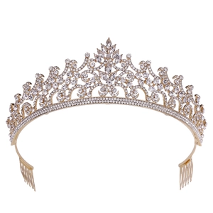 Detailed view of baroque golden tiara featuring red rhinestones and side hair combs