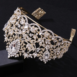 Close-up of golden Baroque crown with crystal flower details and large teardrop gemstone