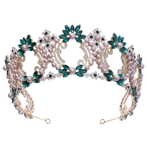 Detailed view of luxury baroque bridal crown with green gems and champagne pearls