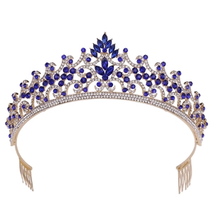 Macro detail of gold bridal crown with blue marquise gems and vine-like rhinestone patterns