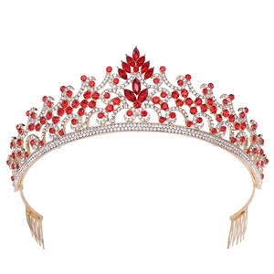 Detailed macro view of baroque gold crown with red rhinestones and side combs