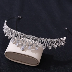 Close-up of silver bridal crown featuring flower patterns and pear-shaped zircon drops