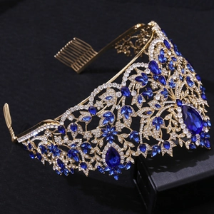 Detailed macro view of gold Baroque crown with deep blue crystals and white rhinestones