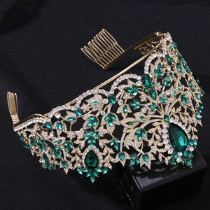 Detail of emerald green gemstones and white crystals on a gold Baroque tiara with hair combs