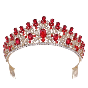 Detailed view of Baroque bridal crown with red crystals and gold-tone hair combs