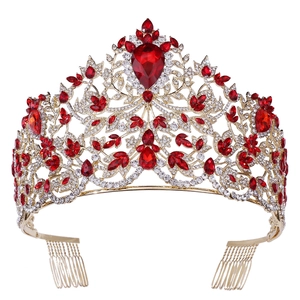 Detailed close-up of a gold Baroque bridal crown with red gemstones and leaf patterns