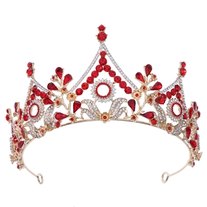 Macro view of gold floral bridal crown featuring red crystals and sparkling rhinestones