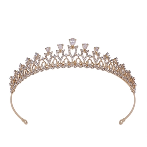 Elegant gold bridal tiara with heart pattern and pear-cut rhinestones on white base