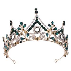 Detailed macro view of green crystal crown with intricate floral gold metal base settings