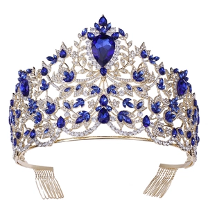 Macro detail of baroque gold tiara with blue crystals and sparkling white rhinestones