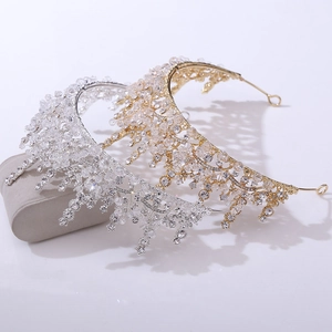 Detailed view of luxury bridal crowns with intricate crystals and beads in gold and silver