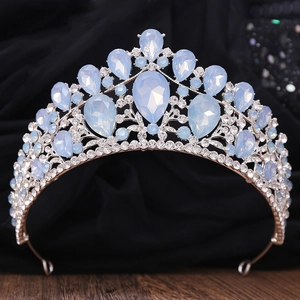 Detailed close-up of a silver tiara with light blue teardrop crystals and rhinestones