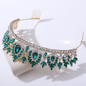 Detailed macro view of the luxury bridal crown with emerald green teardrop crystals