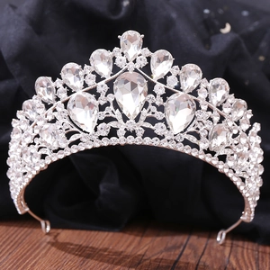Detailed view of luxury silver bridal crown with shimmering crystals on black velvet
