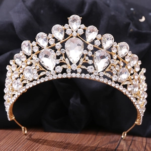 Macro shot of gold bridal crown with shimmering white water-drop crystals and rhinestones