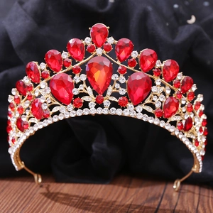 Detailed macro view of luxurious gold tiara featuring ruby red teardrop rhinestones