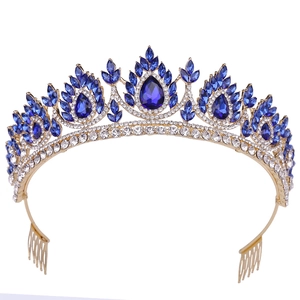 Detailed close-up of a gold bridal crown featuring teardrop blue crystals and clear zircons