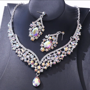 Elegant silver V-shaped necklace and teardrop crystal earrings set with colorful rhinestones
