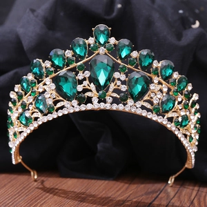 Detailed macro shot of luxury bridal tiara with emerald green stones and golden finish