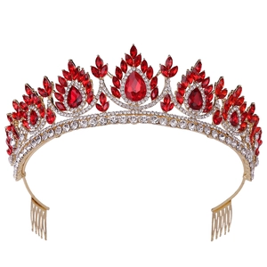 Detailed macro view of the gold tiara base showing red crystals and side hair combs