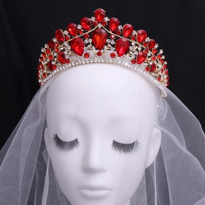 Luxury bridal crown with red teardrop gemstones and crystals on golden base