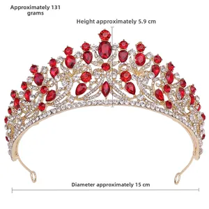 Close-up of luxury bridal crown featuring red pear-cut rhinestones and gold alloy frame