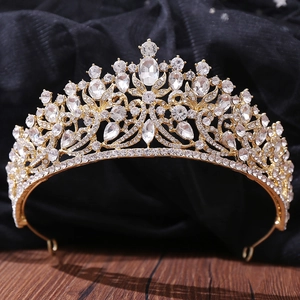 Macro detail of royal gold bridal crown featuring pear-shaped crystals and ornate alloy patterns