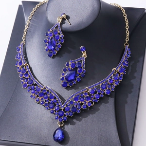 Luxury bridal jewelry set with blue teardrop crystals and gold necklace with drop earrings