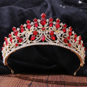 Detailed macro of vintage gold crown with red pear-shaped gemstones and white crystals