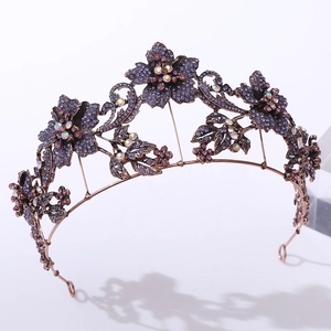 Macro detail of vintage bronze bridal headband with purple rhinestones and floral design