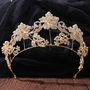 Close-up of a bridal flower tiara with gold floral leaves and sparkling crystal details
