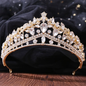 Macro detail of luxury bridal crown with teardrop crystals and gold metal finish