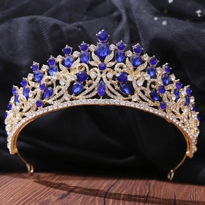 Detailed macro view of baroque golden crown with deep blue crystals and rhinestones