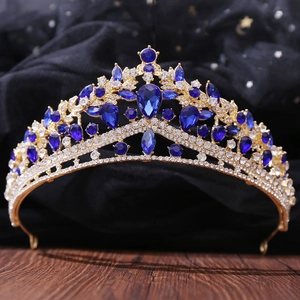 Macro view of luxury bridal crown with deep blue teardrop rhinestones and golden alloy base
