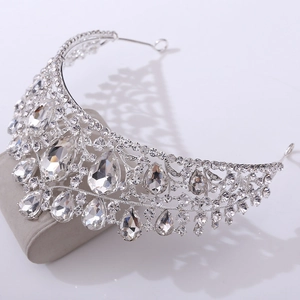 Close-up of silver bridal crown with teardrop rhinestones and baroque crystal details