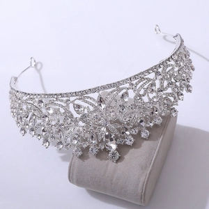 Elegant bridal crown tiara in silver alloy featuring sparkling rhinestones on display stand