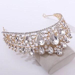 Close-up of golden bridal tiara featuring teardrop crystals and pavé rhinestones