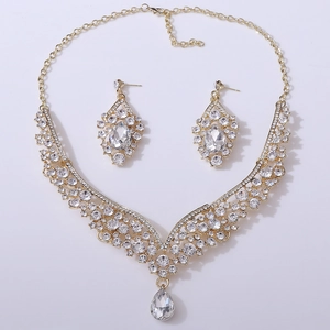 Macro shot of colorful crystal teardrop necklace and earrings bridal jewelry set