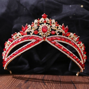 Detailed close-up of luxury gold crown with red gemstones and clear rhinestones