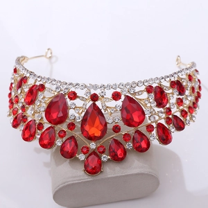 Detailed view of luxury bridal crown with red drop stones and gold alloy frame