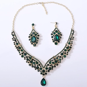 Detailed close-up of emerald green crystal teardrop necklace and matching earrings jewelry set